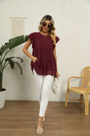 Swiss dot flutter sleeve blouse in Brick Red with tiered ruffle hem and pockets.