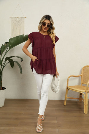 Swiss dot flutter sleeve blouse in Brick Red with tiered ruffle hem and pockets.