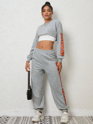 Heather gray graphic sleeve crop sweat set with matching joggers.