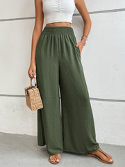 Textured smocked waist palazzo trousers in Matcha Green with wide legs and pockets.