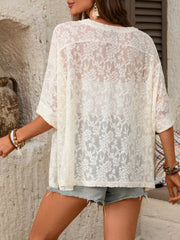 White floral lace sheer top with lace trim and short sleeves.