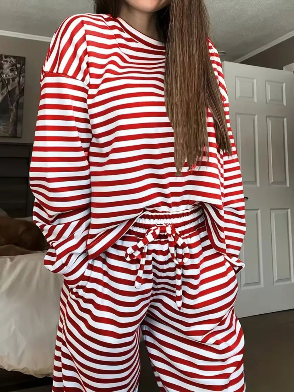Chic striped two-piece lounge set in scarlet and white, featuring a long-sleeve top and drawstring pants.