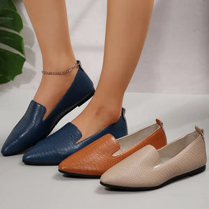 Textured pointed-toe slip-on loafers in navy, ochre, and dust storm with a subtle embossed pattern.