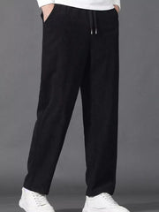 Black corduroy joggers with drawstring waist and pockets.