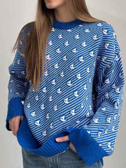 Royal blue knit sweater with white sailboat pattern, crew neck, long sleeves, ribbed cuffs and hem.