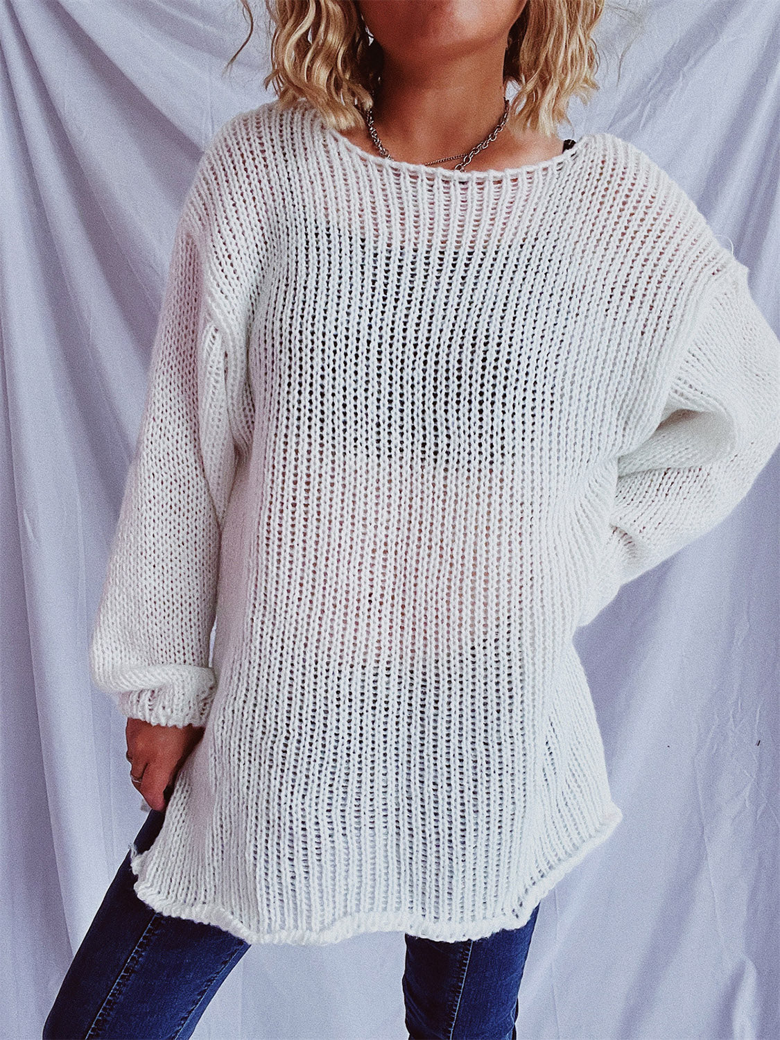 White open-knit slouchy boatneck sweater with long sleeves.