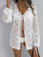 White openwork crochet tie-front cover-up with V-neck and long sleeves.