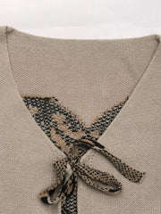Gray apricot knit cardigan with patterned V-neck and tie front detail.