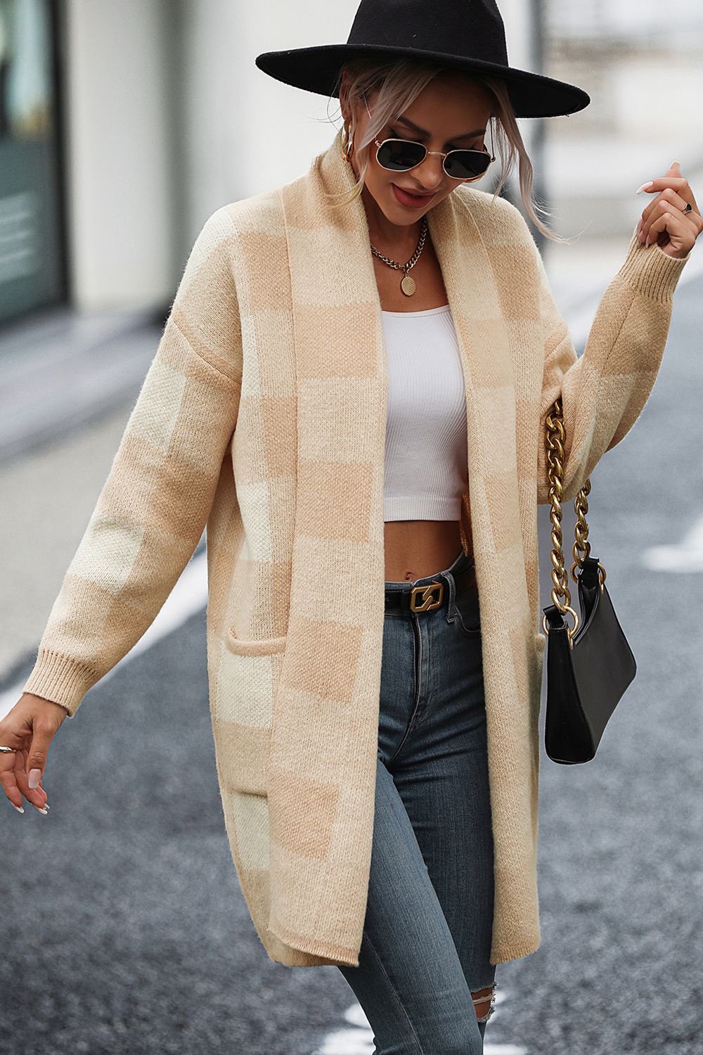 Oversized tan checkerboard knit duster coat with pockets and open front.