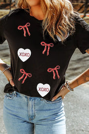 Black cotton t-shirt with sequin heart and bow details