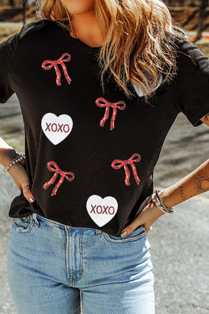 Black cotton t-shirt with sequin heart and bow details