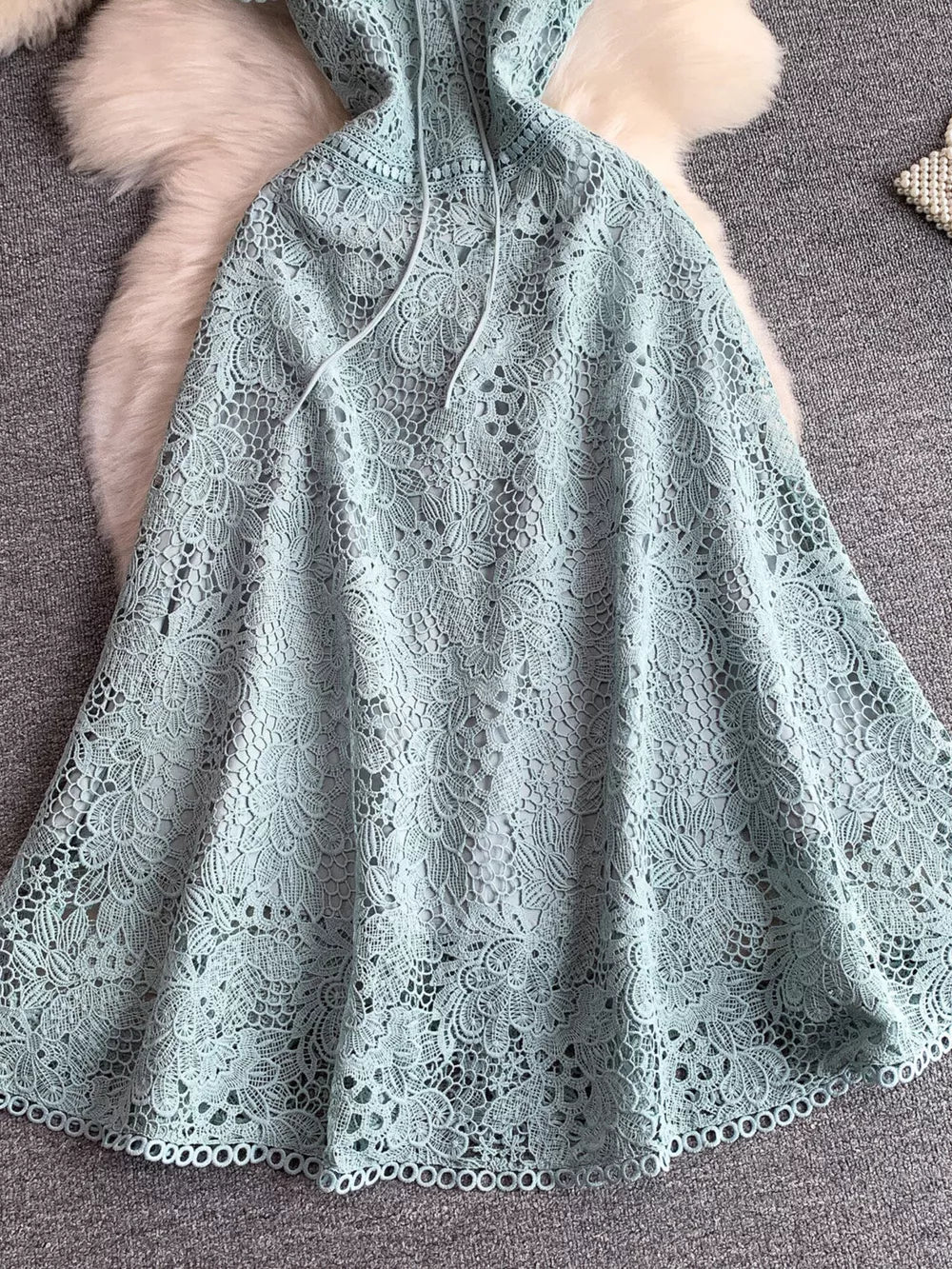 Sky blue floral lace A-line dress with tie detail and cutout design.