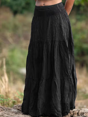 Black tiered maxi skirt with smocked waist and crinkled texture.