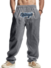 Men's grey sweatpants with motorcycle graphic and drawstring waist.