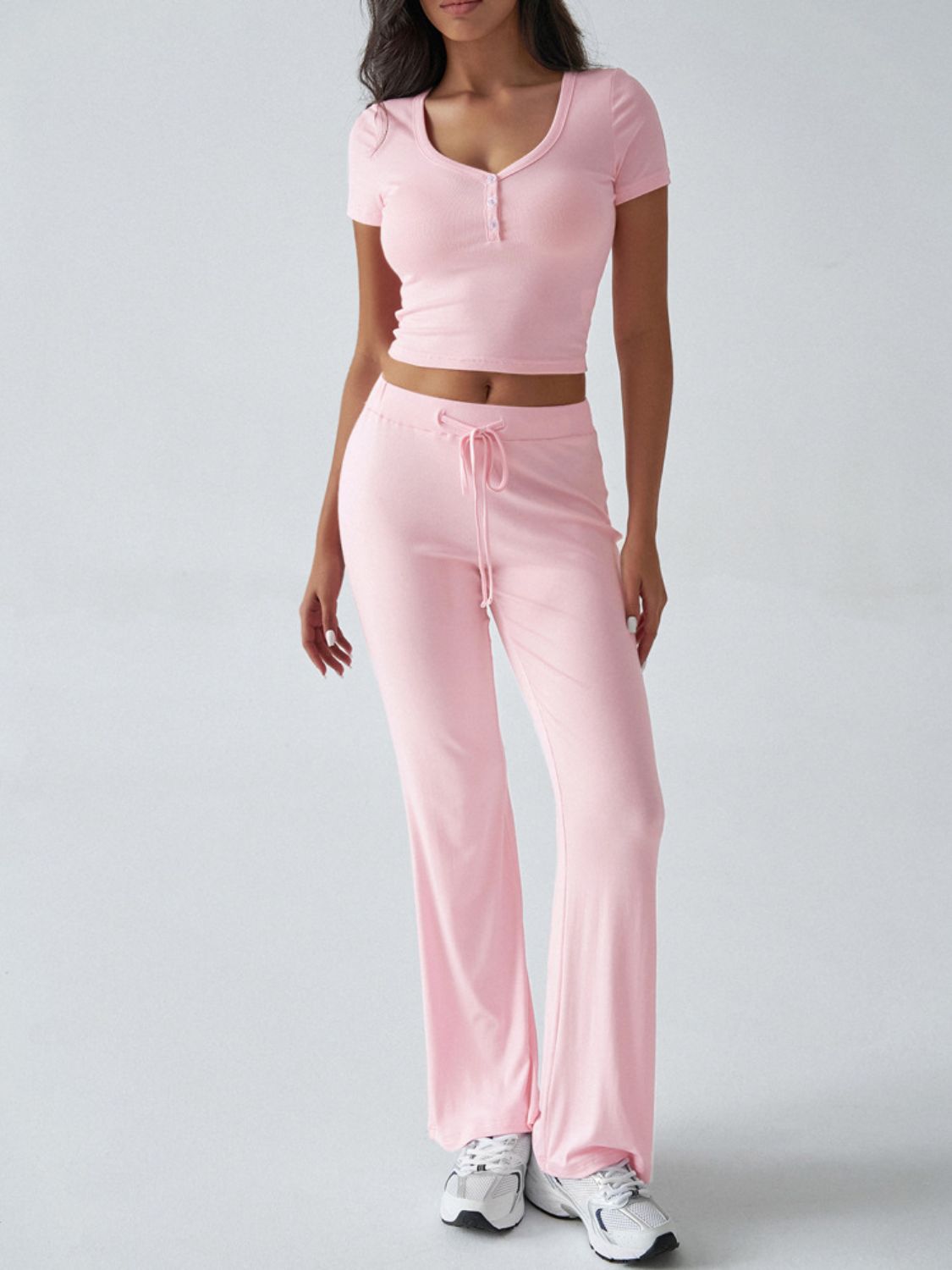 Blush pink button-front crop top and flared lounge pants set with drawstring waist.