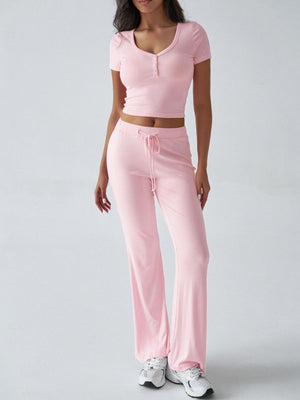 Blush pink button-front crop top and flared lounge pants set with drawstring waist.