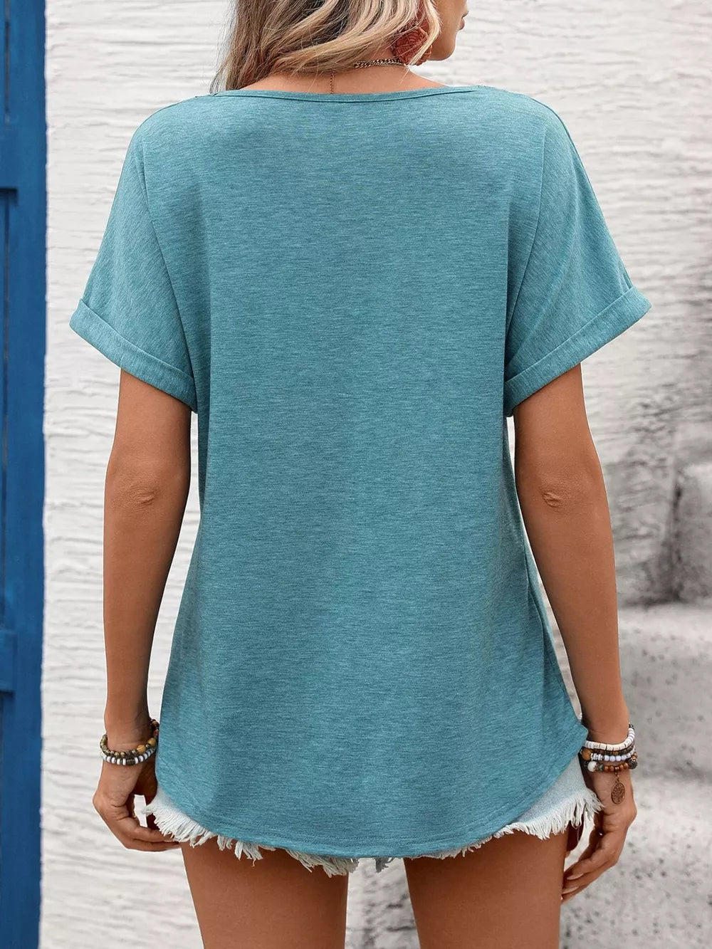 Blue-green relaxed fit t-shirt with cuffed sleeves and lace trim detail.