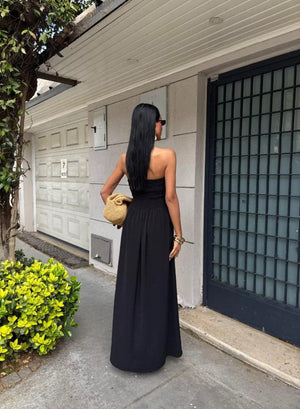Black smocked bodice relaxed maxi dress with a strapless neckline.