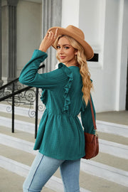 Teal textured ruffle peplum blouse with long sleeves and a cinched waist.
