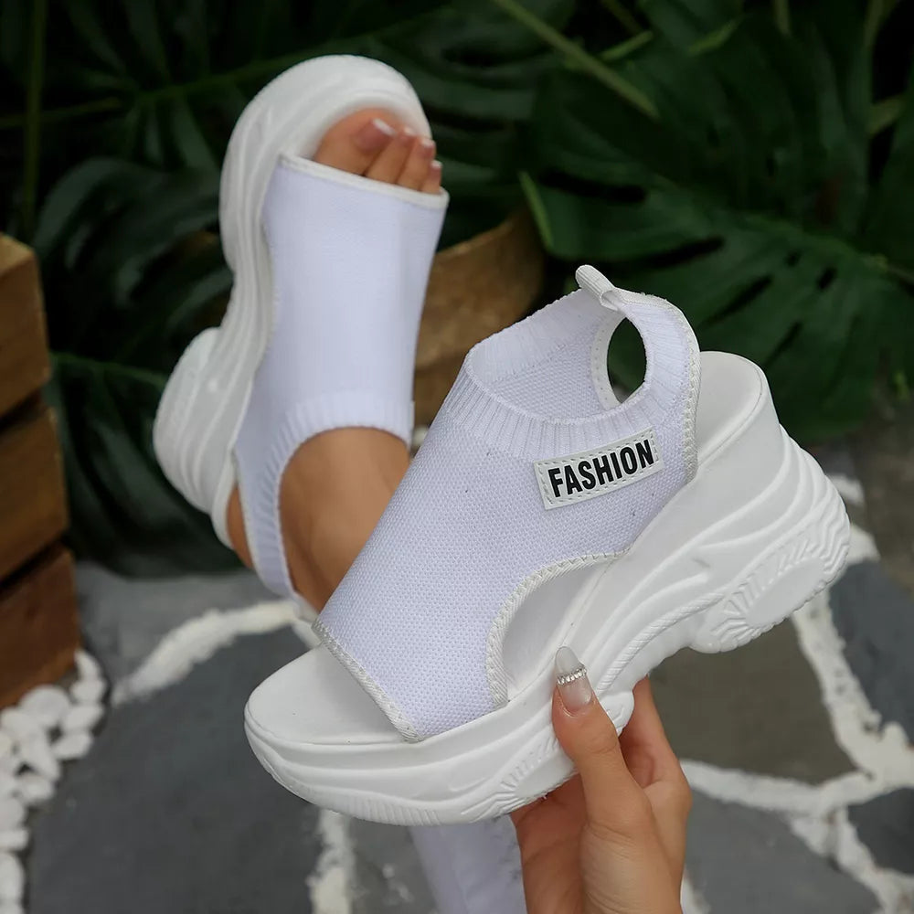 White open-toe wedge sandals with chunky sole and "Fashion" tag