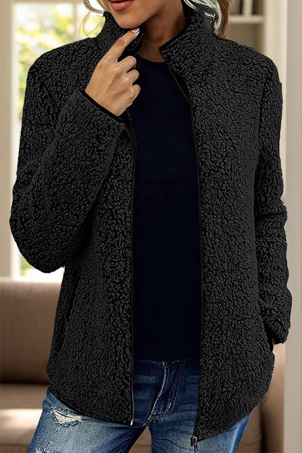 Black teddy fleece zip-up jacket with a stand collar and full zip closure.