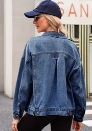 Oversized denim trucker jacket in medium blue wash with button details and a pleated back yoke.