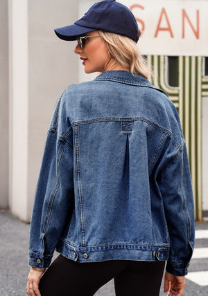 Oversized denim trucker jacket in medium blue wash with button details and a pleated back yoke.