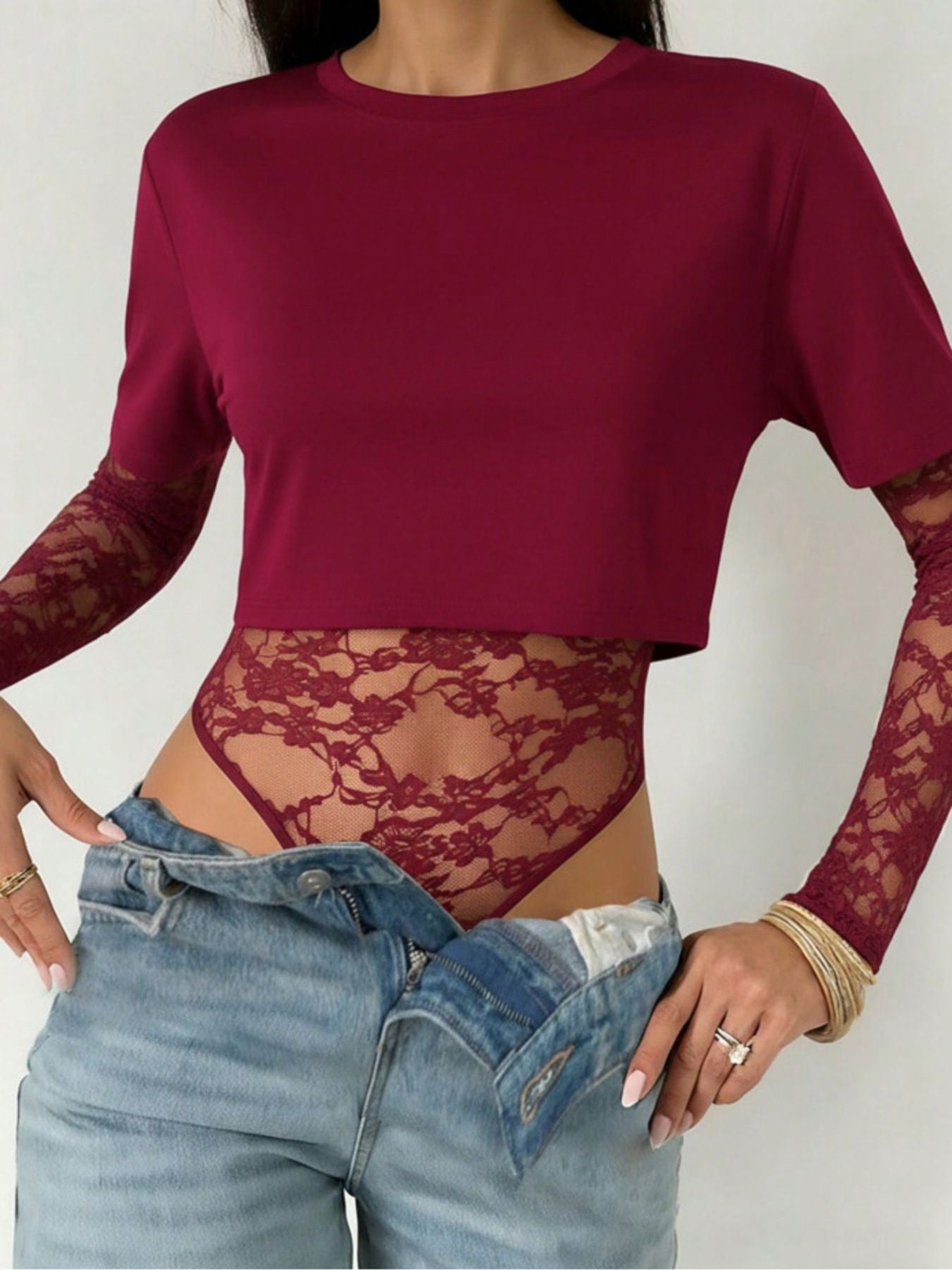 Wine red lace bodysuit with sheer sleeves and floral detail.