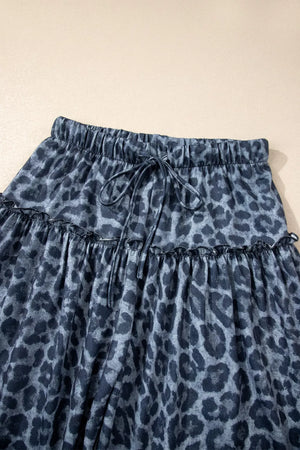 Maternity pants in dark navy with a leopard print, ruffled tiers, and drawstring waist.