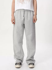 Relaxed fit grey sweatpants with adjustable drawstring waist and wide legs.
