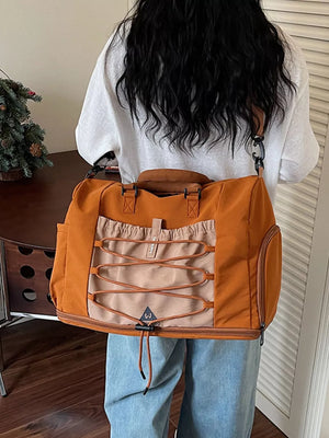 Versatile large nylon duffel bag in orange and beige with bungee cord detail.