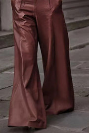 Burgundy wide-leg leather pants with buckle belt detail