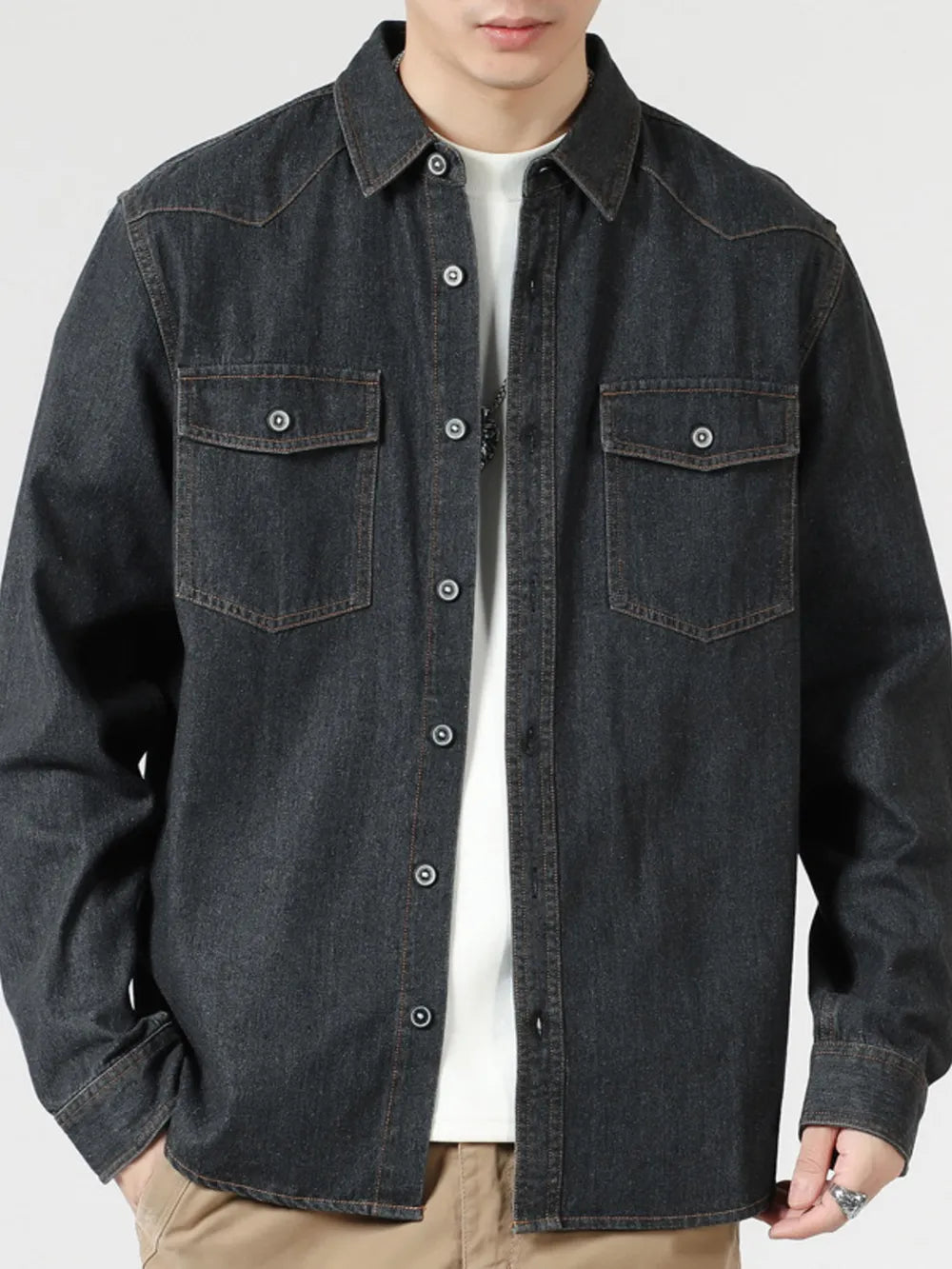 Black relaxed fit denim shirt with buttoned chest pockets and collar.