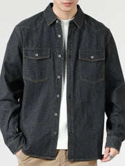 Black relaxed fit denim shirt with buttoned chest pockets and collar.