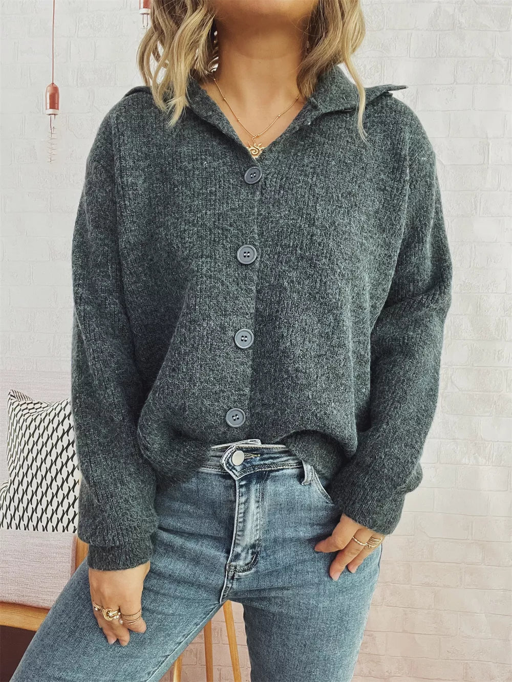 Gray ribbed knit cardigan with polo collar and buttons, styled with jeans.