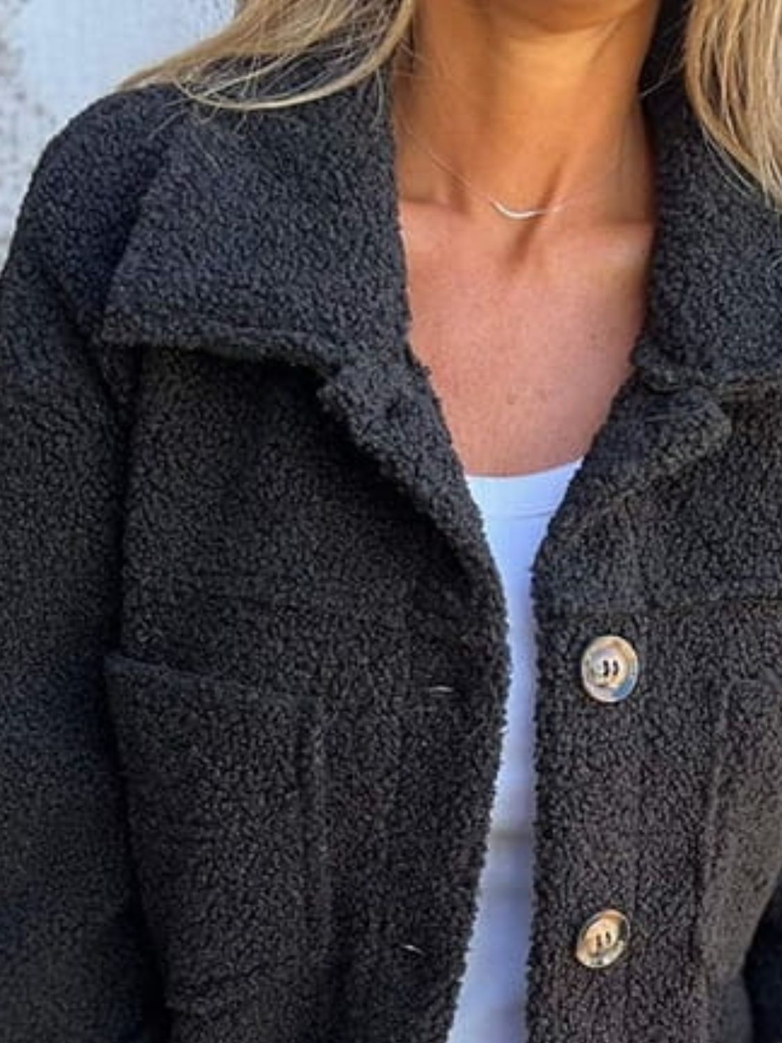 Textured sherpa utility jacket in black with button front and chest pockets.