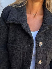Textured sherpa utility jacket in black with button front and chest pockets.