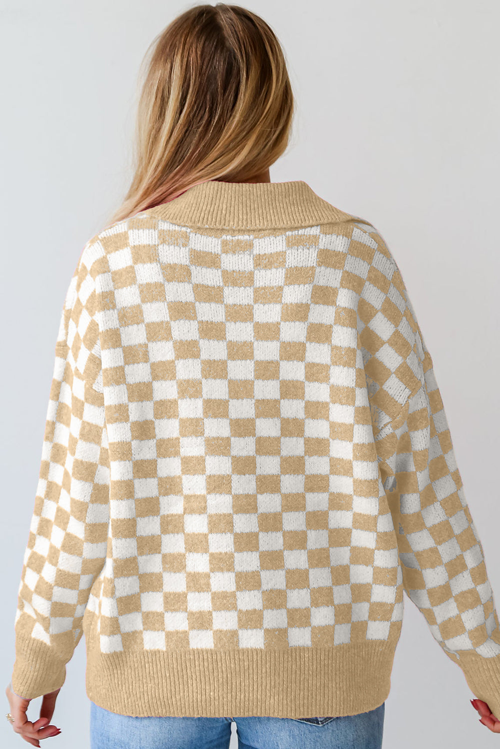 Tan and white checkerboard knit polo sweater with ribbed collar and cuffs.