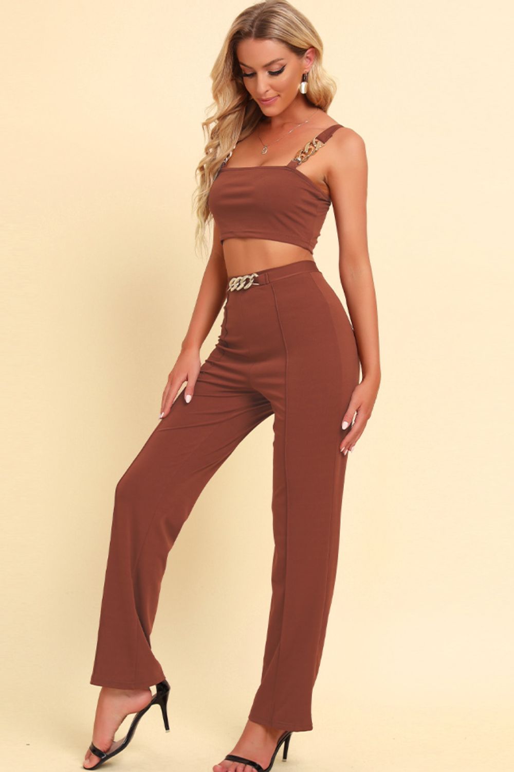 Caramel chain strap crop top and high-waist trousers set with gold chain details.