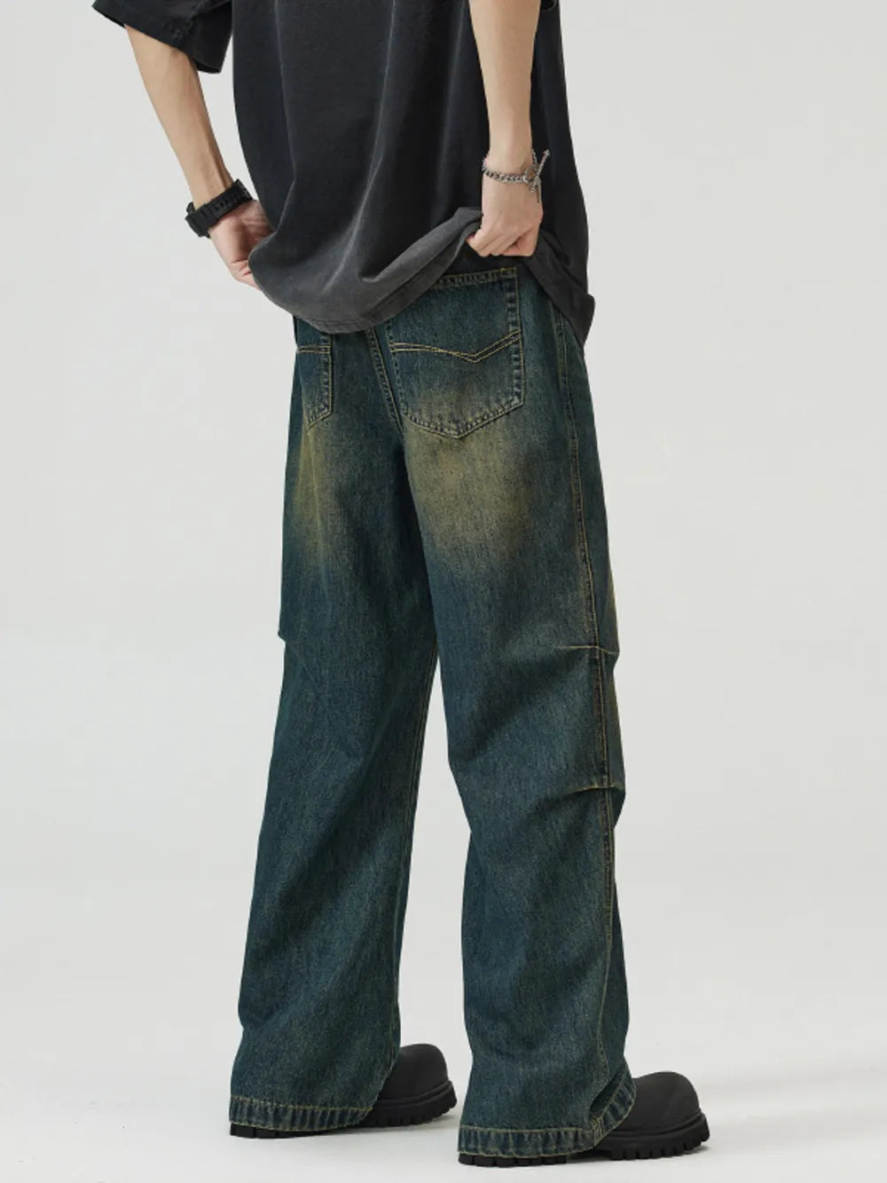 Vintage wash wide-leg men's jeans in dark blue-green denim with a relaxed fit.