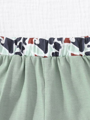 Sage green baby shorts with elastic waistband and camouflage print trim
