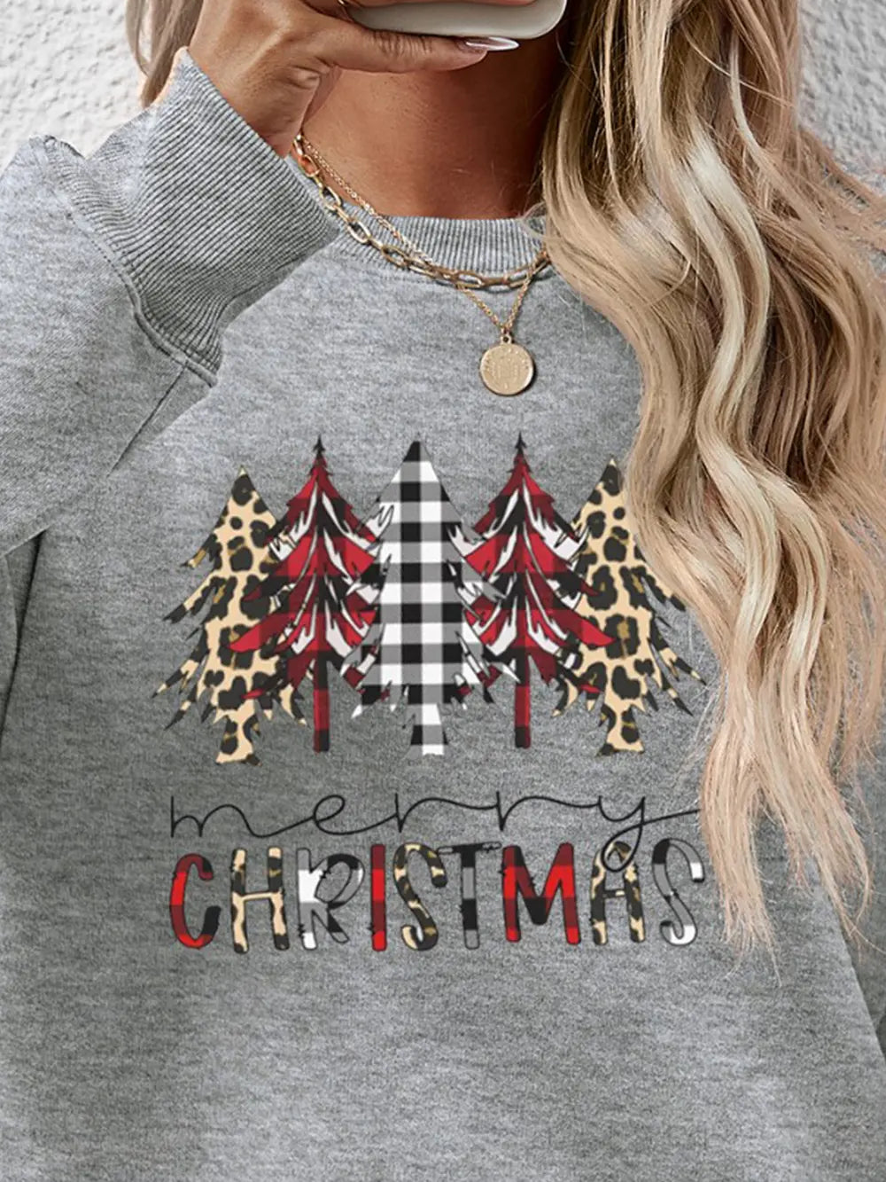 Christmas graphic print crewneck sweatshirt in gray with buffalo plaid and leopard trees and text.