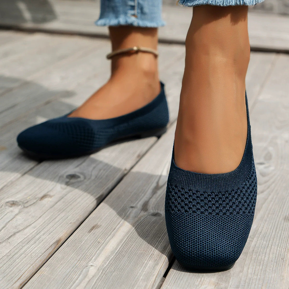 Dark blue knit square-toe flats with a textured pattern on the toe.