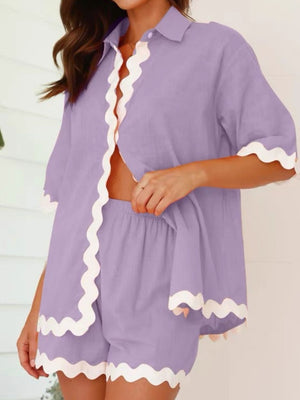 Lilac linen pajama set with scalloped trim, short sleeves, and shorts.