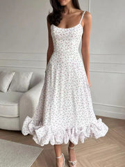 White floral midi dress with spaghetti straps and a ruffled hem