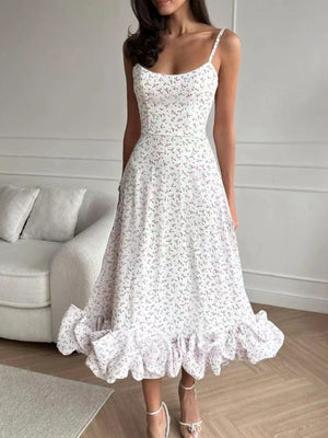White floral midi dress with spaghetti straps and a ruffled hem
