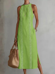 Light green sleeveless midi dress with geometric trim and pockets.