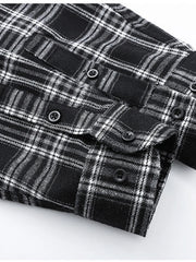 Men's black plaid button-up shirt with cotton blend fabric and button details.