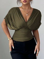 Army green ruched surplice dolman sleeve top with a deep V-neckline.