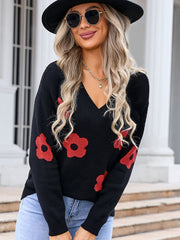 Black V-neck knit sweater with red daisy print, long sleeves, acrylic.